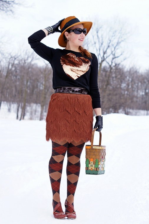 Brown skirt, black top with brown heart, brown hat and tights