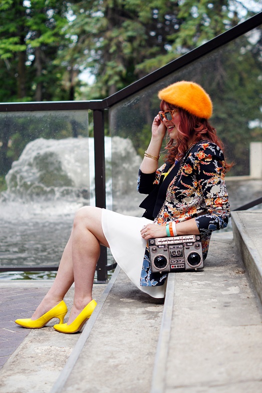 Orange beret, white skirt, yellow shoes, patterned jacket