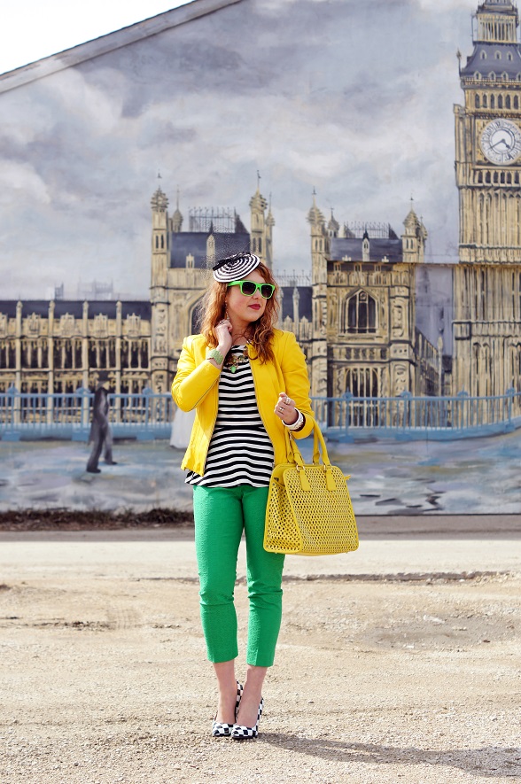 green pants, yellow jacket and purse with black and white blouse
